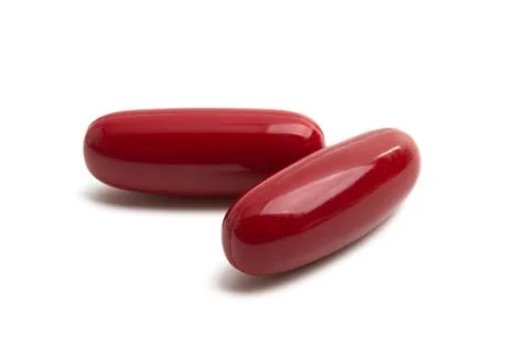 Red capsules isolated Stock Photos