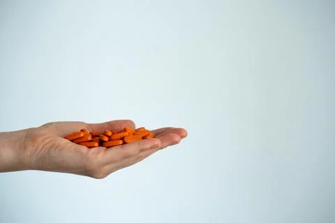 Red capsules in open hand close up Stock Photos