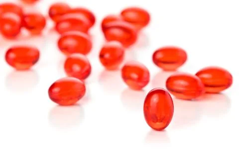 Red capsules. Stock Photos