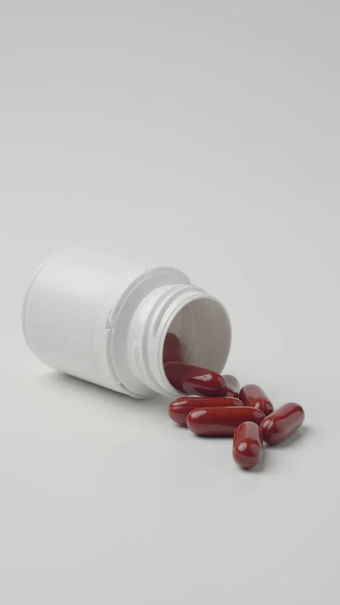Red Capsules Spilled From Plastic Bottle Stock Footage 346972456