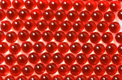 Red capsules on a white background close-up. Stock Photos