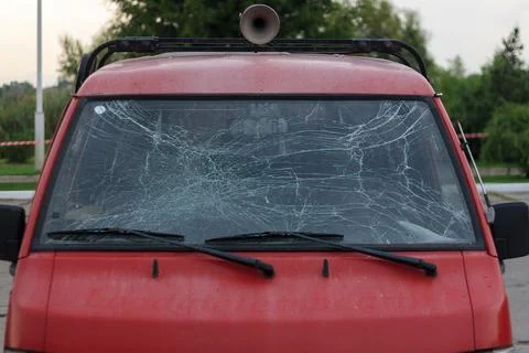 Red car with broken windscreen after crash on road or traffic accident Stock Photos