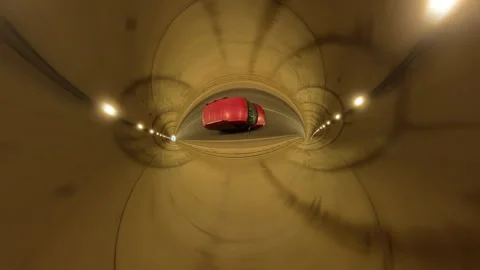 Red Car Captured in Tiny Planet Effect Driving Through a Well-Lit Tunnel with Video stock 297677620