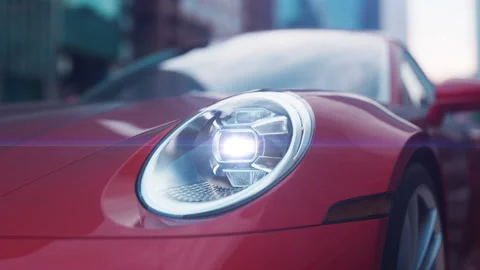 Red car close-up shines headlights in urban environment camera movement with  Stock Footage 232204094