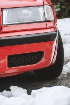 Red car close up view of front lights,ready for travel at cold winter day Stock Photos