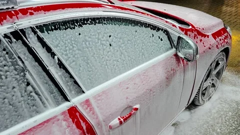 Red Car Covered In Thick Foam During Automatic Wash Close Up View Vidéo 332761239