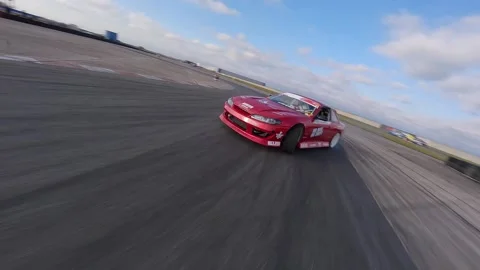 Red Car Drifts Dynamically with FPV Front and Side Shots Stock Footage 325449939