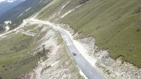 Red car driving on high mountain road. Stock Footage 336333305