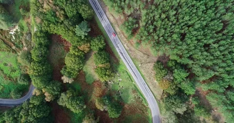 A red car driving on a windy mountain road, aerial view with drone Stock-Footage 283388504