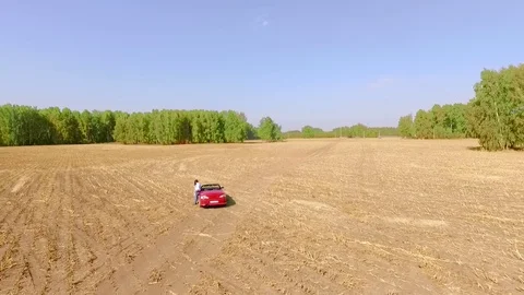 Red car in feeld. Areal Video stock 70715908