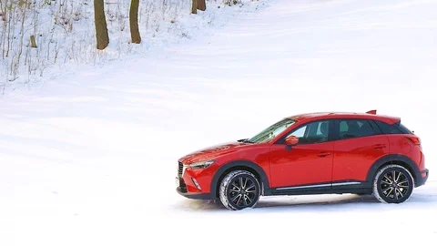 Red car goes on snow Stock Footage 87330399