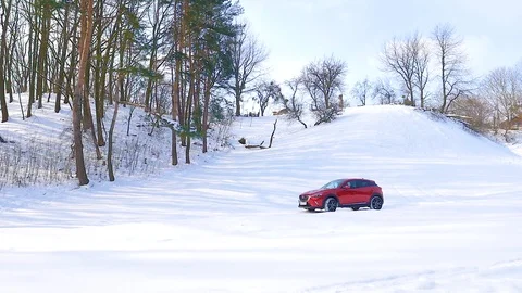 Red car goes on snow Stock Footage 87330691