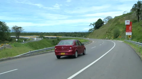 Red car is going to cross the bridge road Stock Footage 60982205