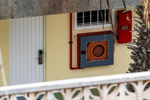 A red car is hanging from a window Stock Photos