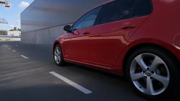 Red car hatchback driving on road on background industrial building Stock Footage 85830431