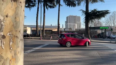 Red car makes turn through double solid line near pedestrian crossing Video stock 307720447