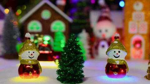 A red car moves through the middle of a Christmas town Stock Footage 295479642