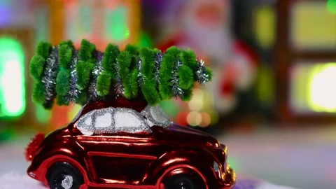 Red car moving on floor with blurred background of Christmas town Stock Footage 295484052