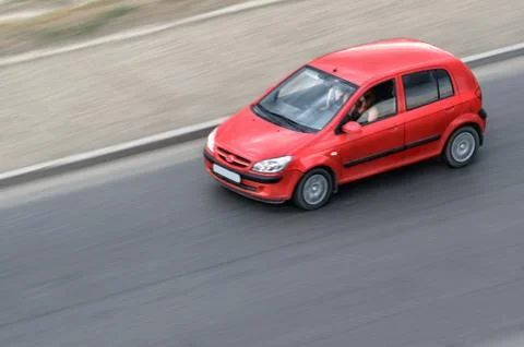 Red car moving Stock Photos