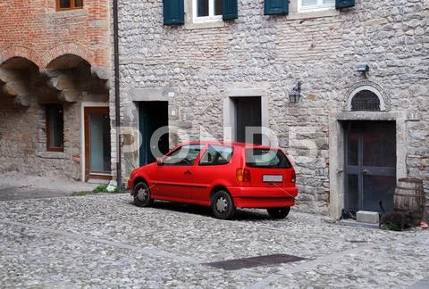Red car in old town Stock Photos