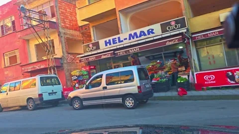 A red car is parked in front of a building Stock Footage 272998580