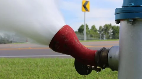  Red Car Passes in Background of Fire Hydrant While Flushing Stock Footage 52888965