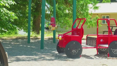 Red car playground equipment structure in public park sandbox 動画素材 337306917