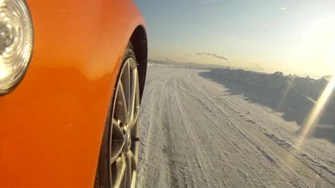 Red car rides through the snow, the sun shines Stock Footage 154428018