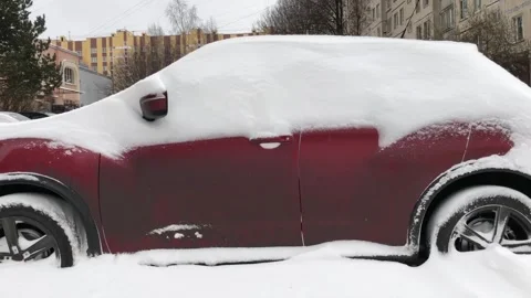 Red car side view, covered with a thick layer of snow Stock Footage 260079920
