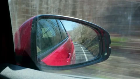 Red Car Side View Mirror Reflection of country Road Stock Footage 332498386