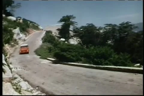 Red car speeding down mountain road Video stock 11350676