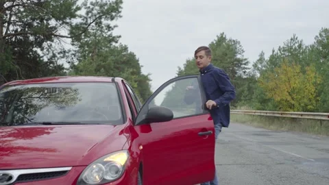 The red car stops on the side of the road due to a malfunction Stock Footage 237283994