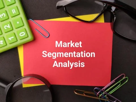 A red card reading Market Segmentation Analysis sits among a green calculat.. Stock Photos
