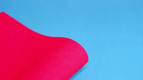 Red cardboard on a blue background. The texture of the cardboard. Stock Footage 157393222