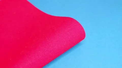 Red cardboard on a blue background. The texture of the cardboard. Stock Footage 157555048