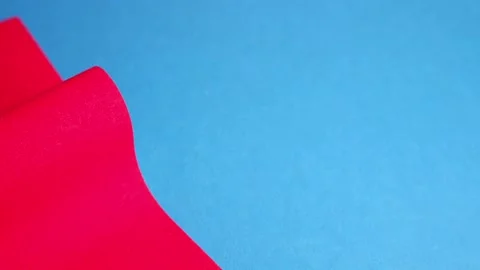 Red cardboard on a blue background. The texture of the cardboard. Stock Footage 158016704