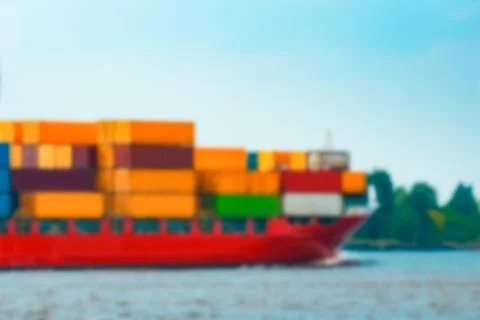 Red cargo ship - blurred image Stock Photos