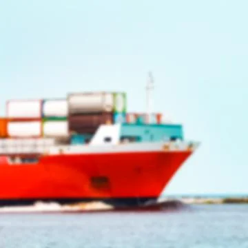 Red cargo ship - blurred image 스톡 사진