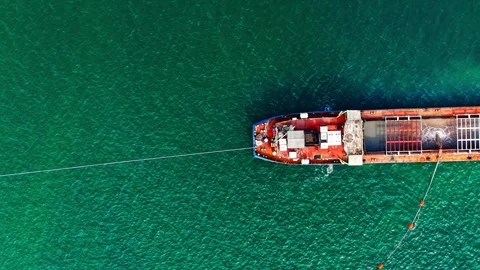 Red cargo ship with tow line viewed from directly above, Black Sea, Bulgaria Video stock 337197815