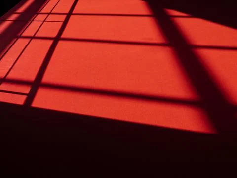 Red carpet with abstract lines on surface, sunlight on red rug Stock Photos