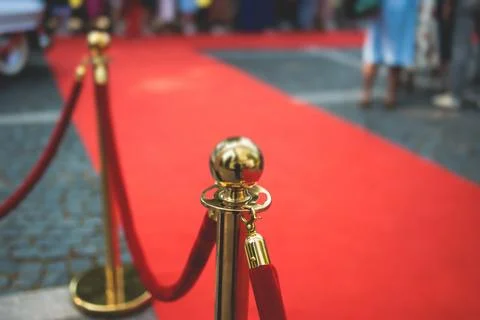 Red carpet with ropes and golden barriers on a luxury party entrance, cinem.. Stock Photos