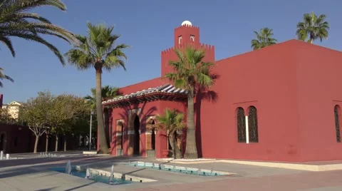 Red castle Bil Bil deep blue sky palm trees Stock Footage 57201030
