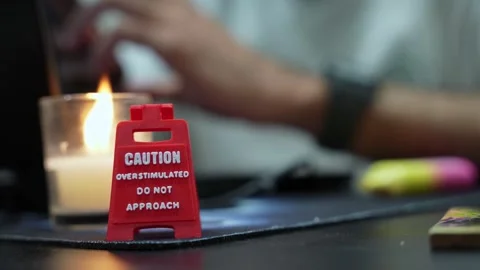 Red Caution Overstimulated Sign On Office Desk Stock Footage 335958883