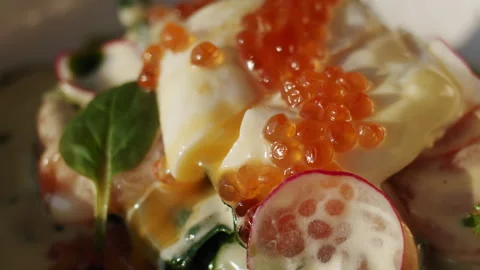 Red caviar and poached egg in a benedict sandwich in the sun in slow motion Video stock 151296203