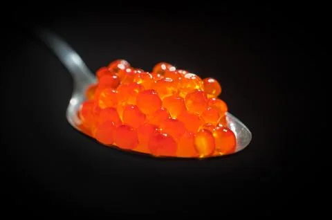 Red caviar on Black Background Stock Photos