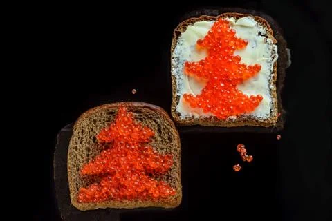 Red caviar on black bread in the form of a Christmas tree Stock Photos