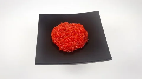 Red caviar on the black plate close up rotation, 4K Stock-Footage 48014102