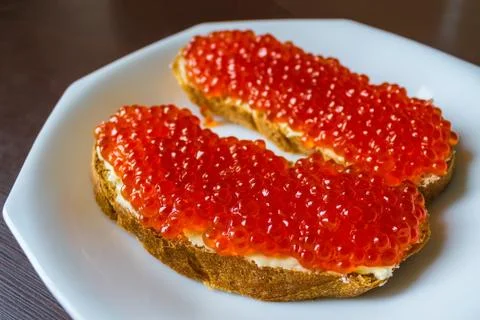 Red caviar on bread. Stock Photos