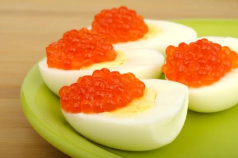 Red caviar on chicken egg Stock Photos