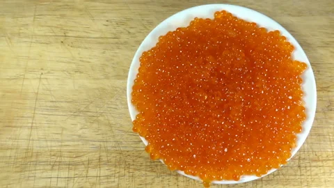 Red caviar drops in slow motion on a plate Stock Footage 131871001